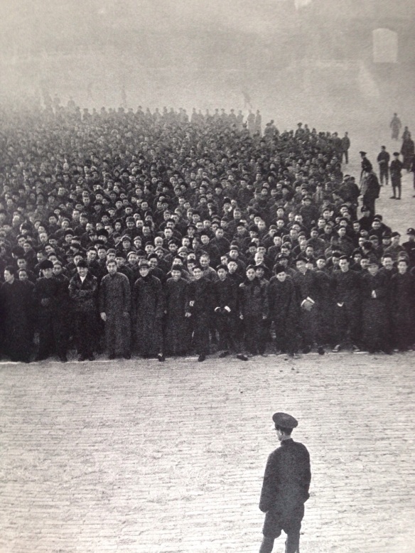 Eight o'clock in the moring at the Imperial Palace in Peking.  Ten thousand recruits, mobilized principally from the ranks of small traders, line up to form a new Nationalist regiment.
